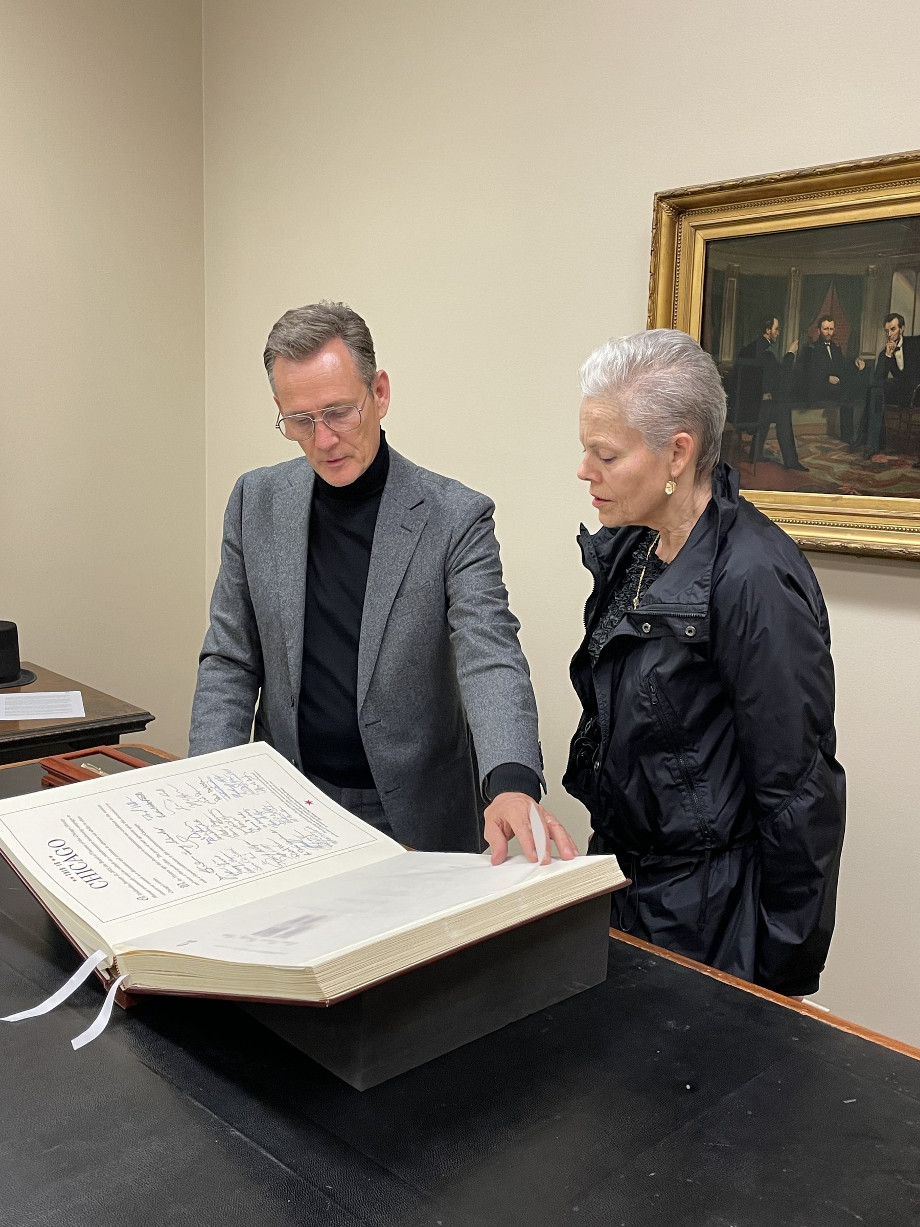 Guild and Costume Council member Elizabeth Price examines the Lincoln Honor Roll book